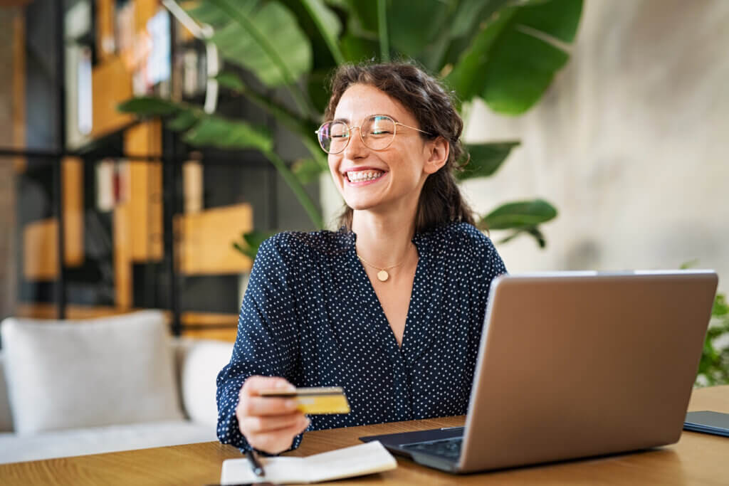 Woman shopping with channel incentive rewards online with laptop