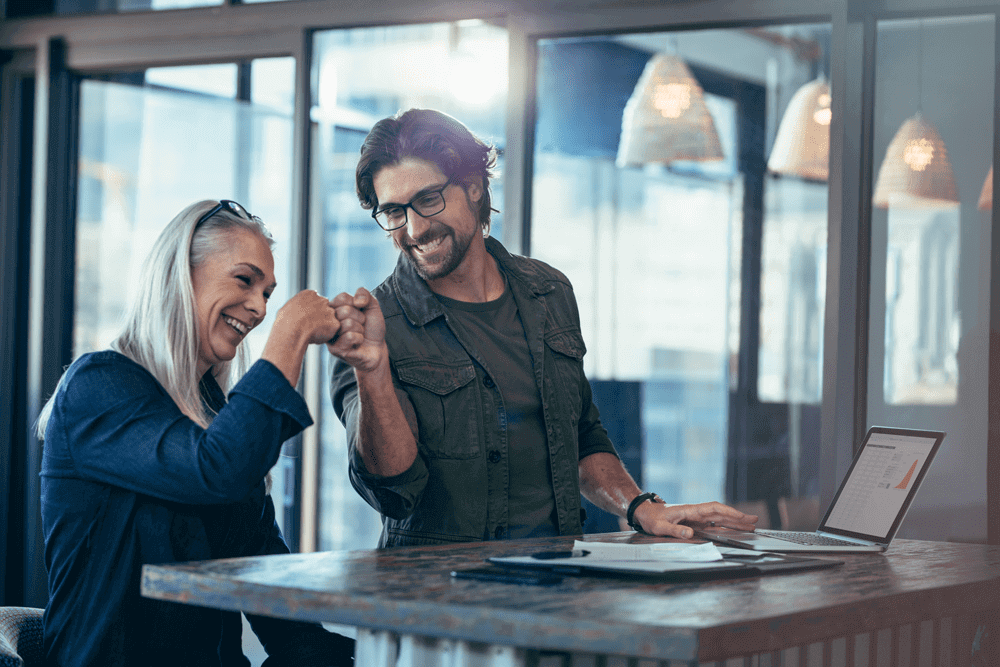 Business colleagues making a fist bump at office