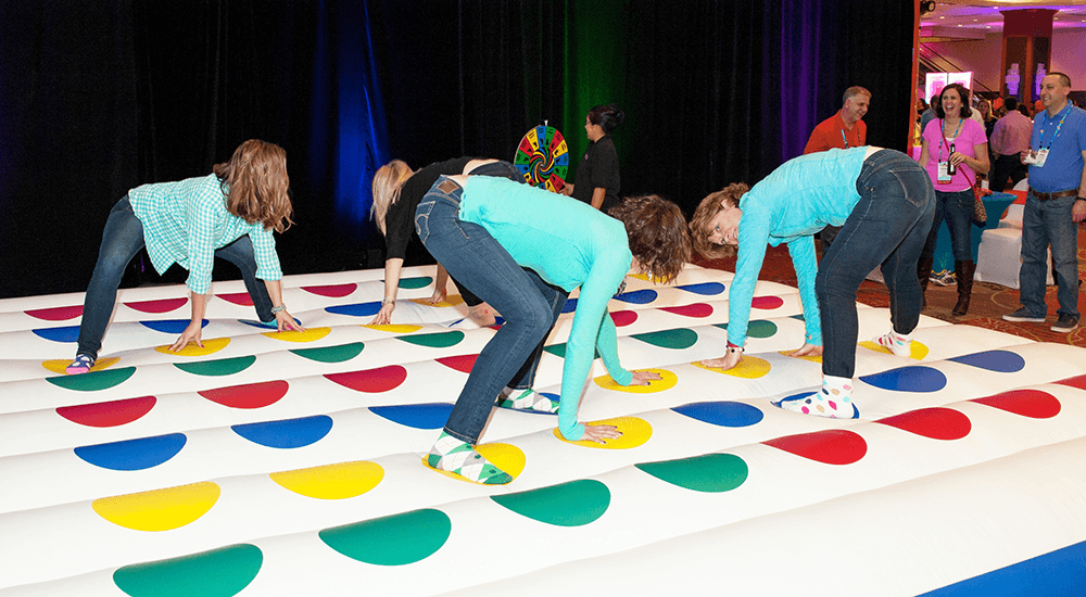 a group of people at a conference playing Twister game