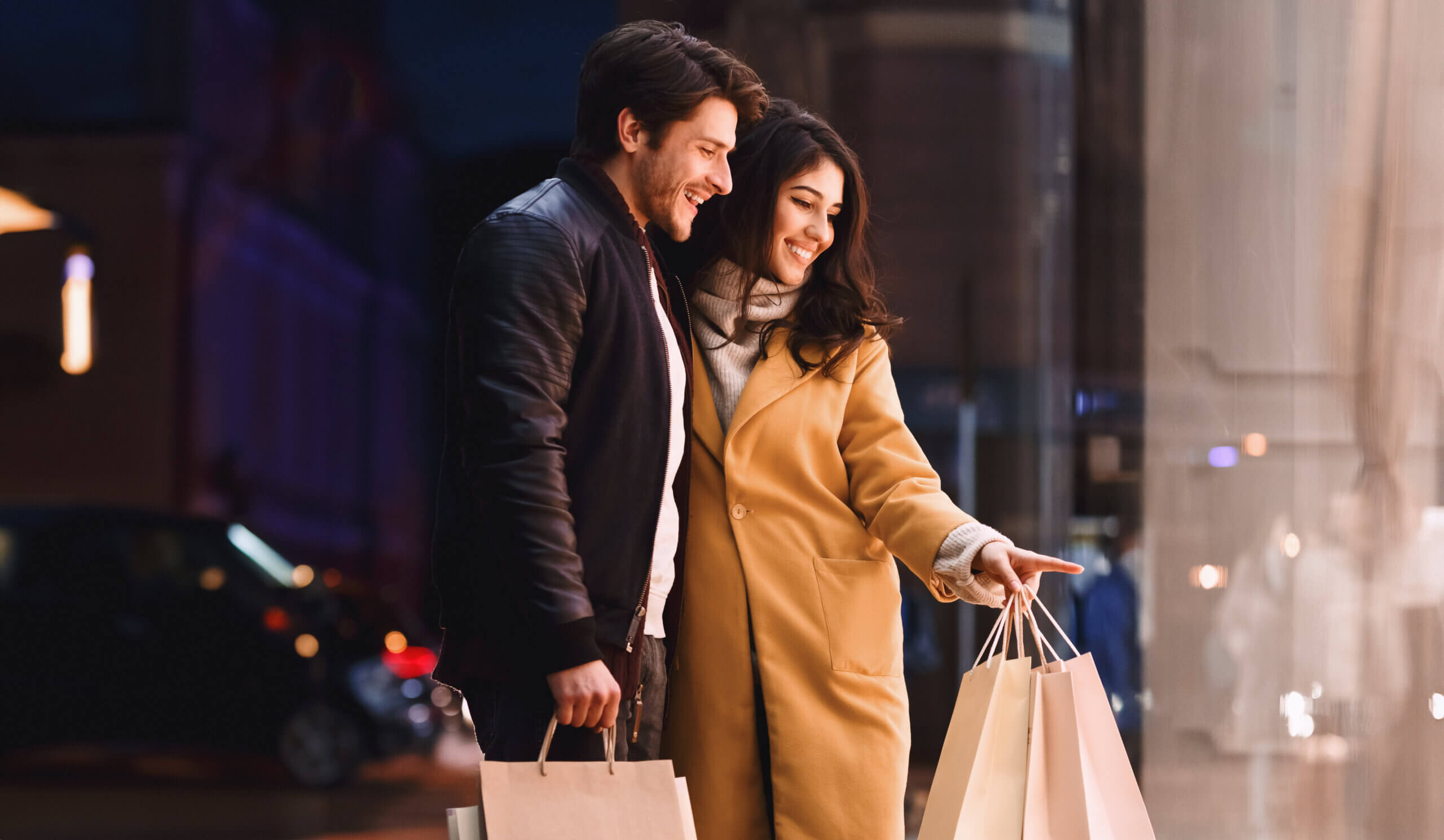 Couple Holding Shopping Bags in Front of Store