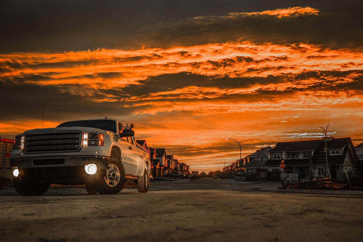 Truck in the foreground with a sunset behind