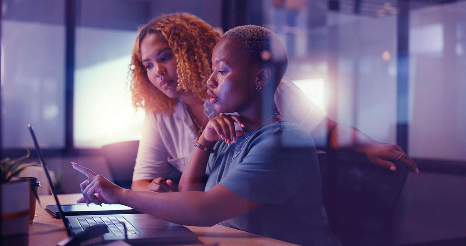 two women looking at computer screen