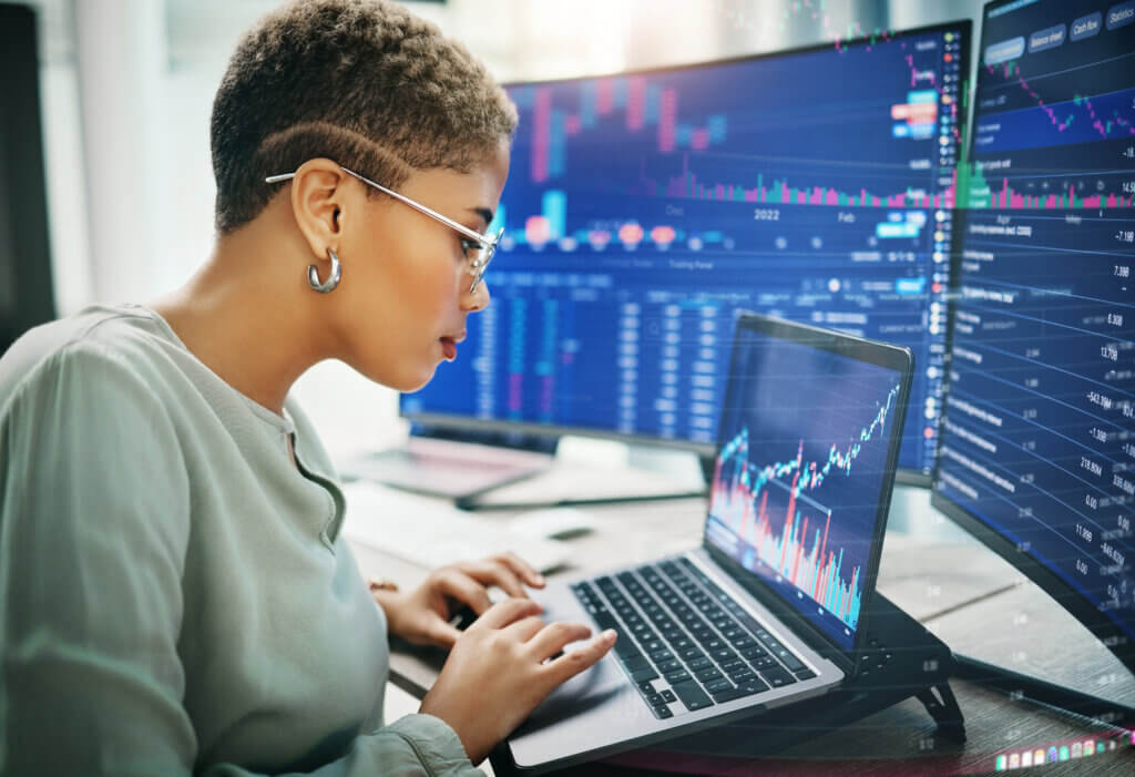 Laptop, investment graphs and business woman reading IPO analytics, financial bank chart or accounting value, info or stocks. Trade price, admin data analysis and profile of broker review statistics.