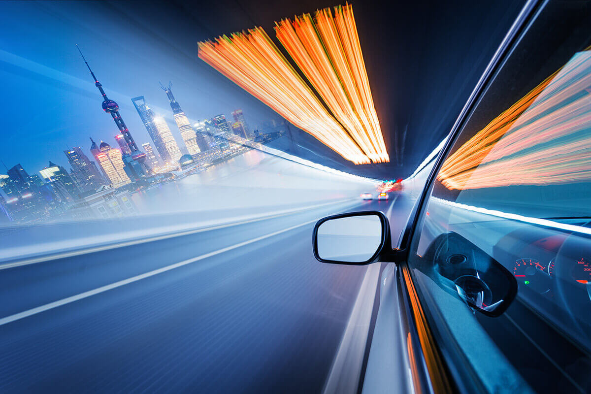 Vehicle mirror POV traveling through nighttime tunnel