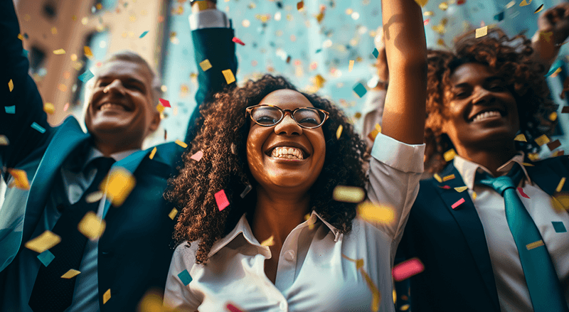 three people celebrating with confetti falling