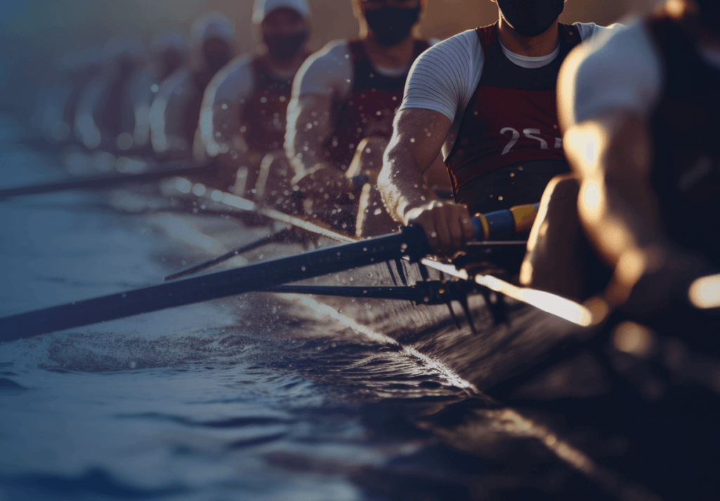 rowing team in a boat on the water with oars