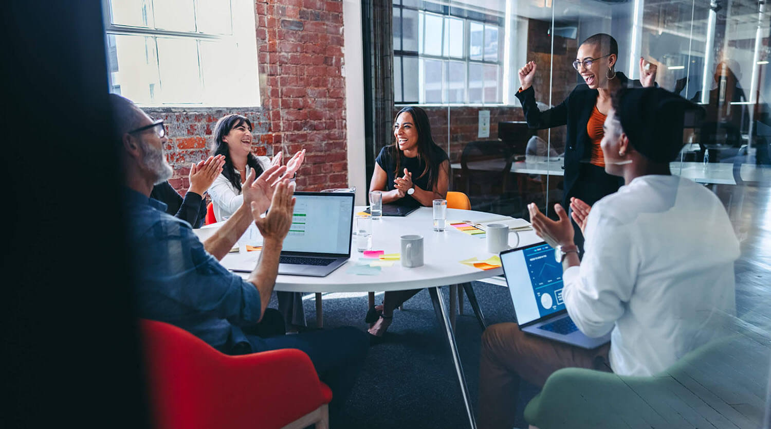 Cheerful group of coworkers around table