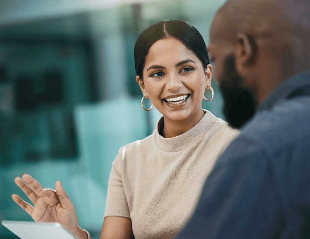 woman and man talking about a document together in the workplace