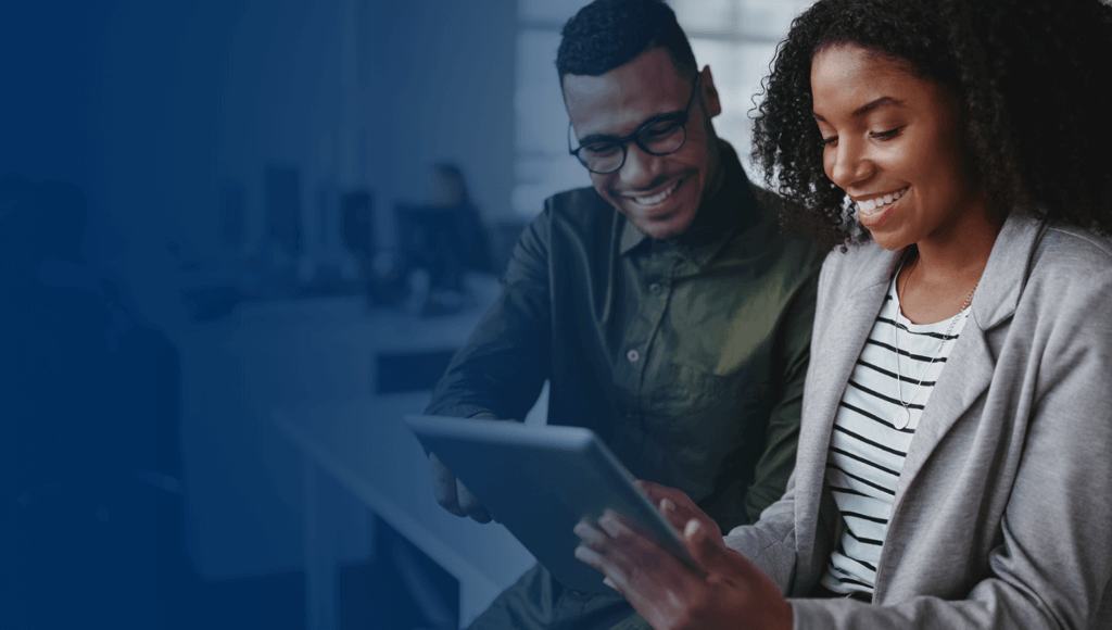 two people in an office using a tablet