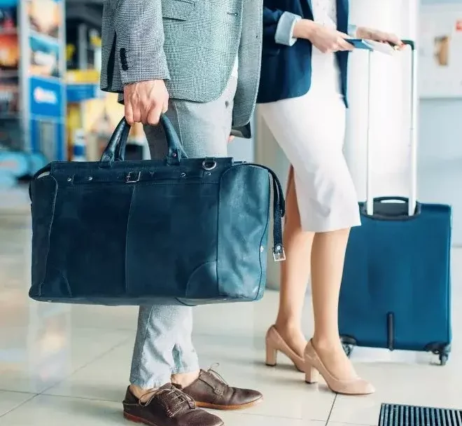 man and woman with luggage at airport-jpg