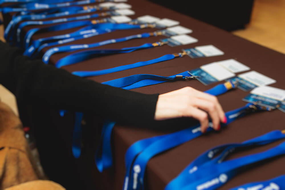 conference table showing event badges and lanyards