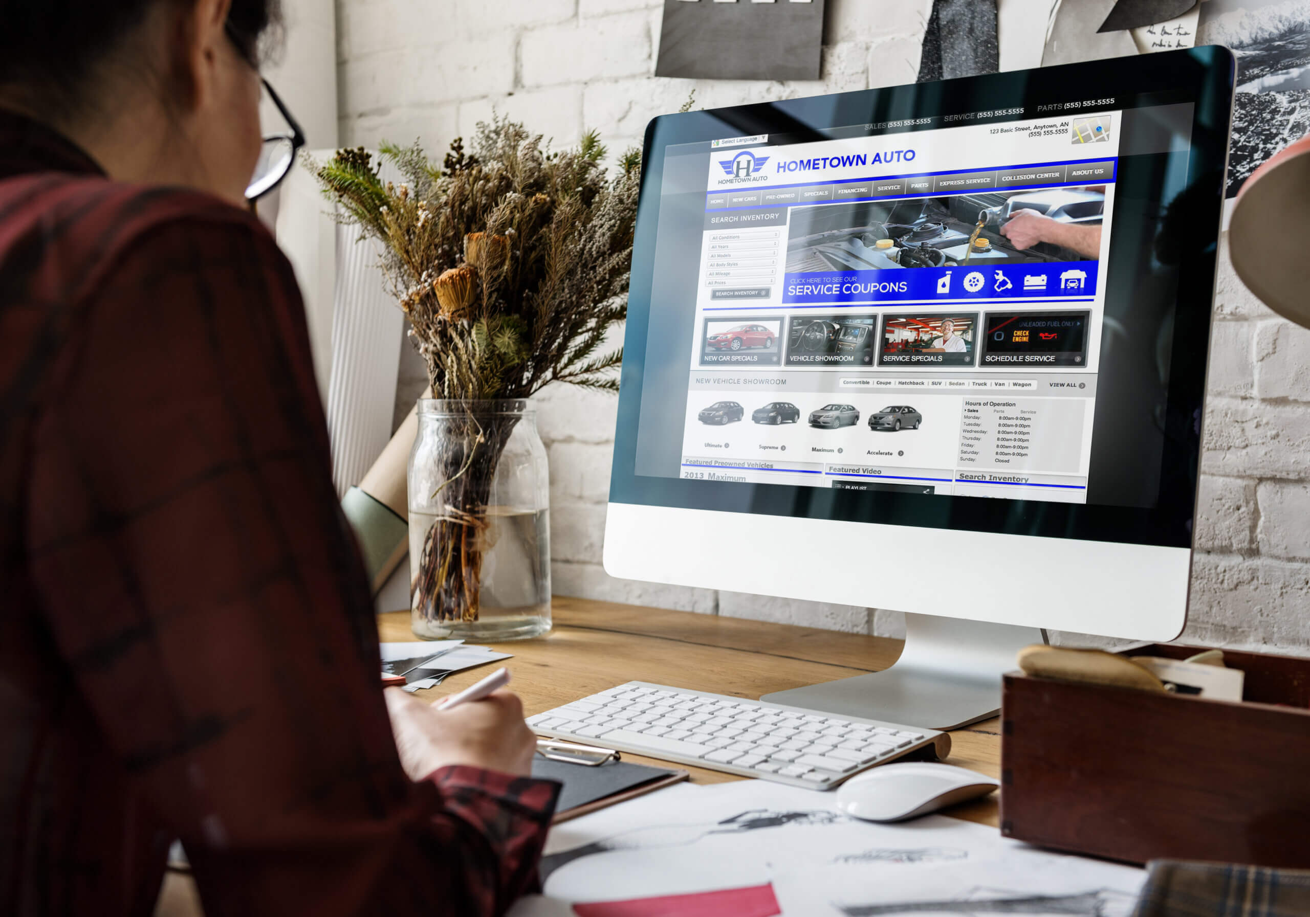 Person viewing the 'Hometown Automotive' website on a desktop computer.