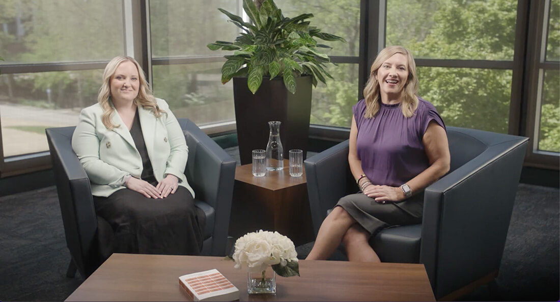 two business women sitting and talking as video intro