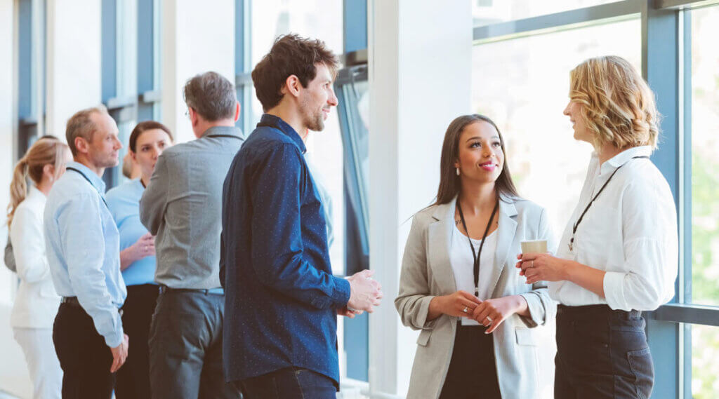 people gathered and talking at a conference