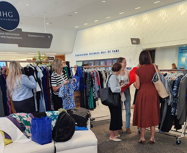 women shopping racks of clothing