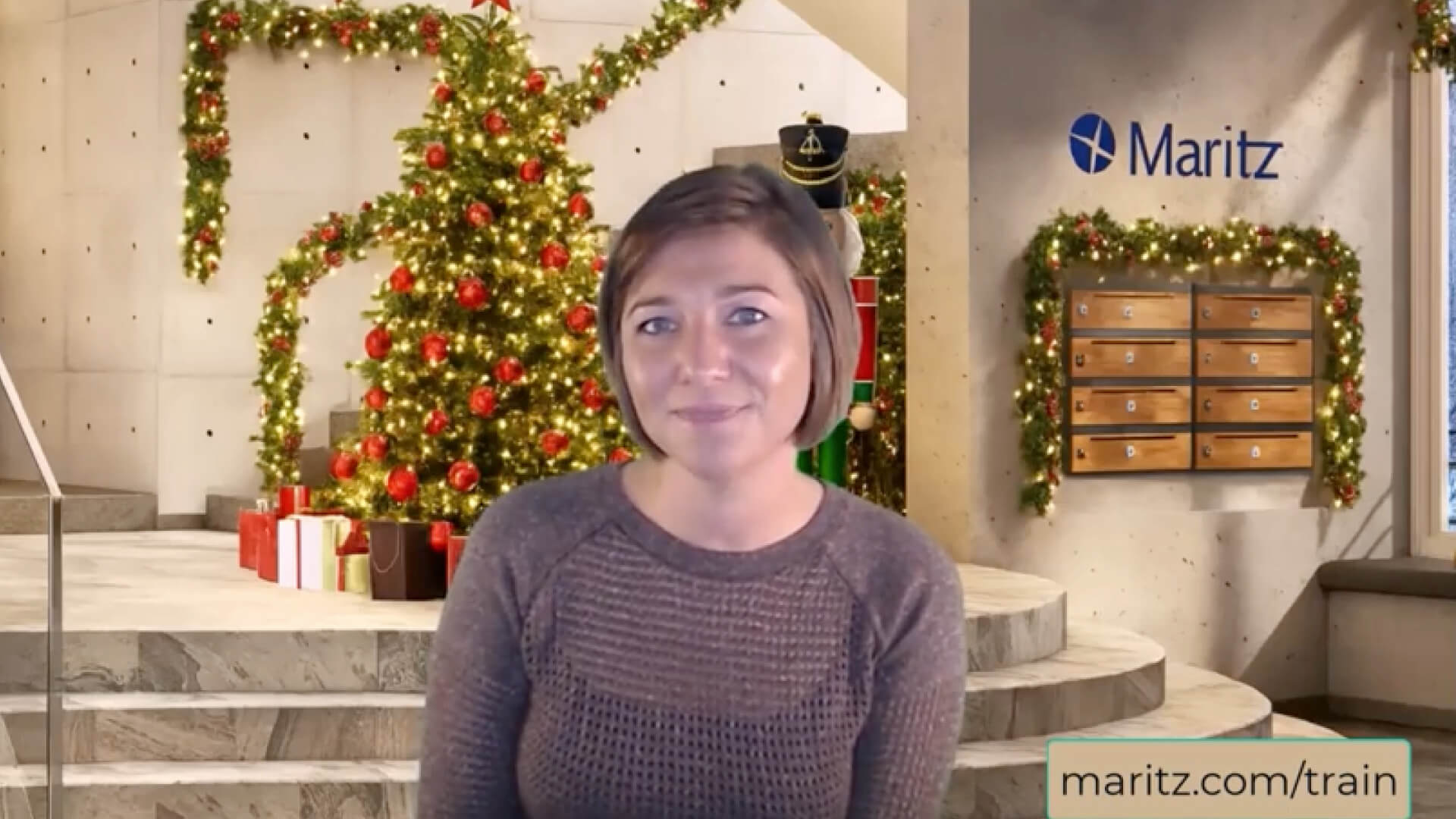 Video preview cover image showing a person standing indoors in front of a festive holiday backdrop with greenery and ornaments.