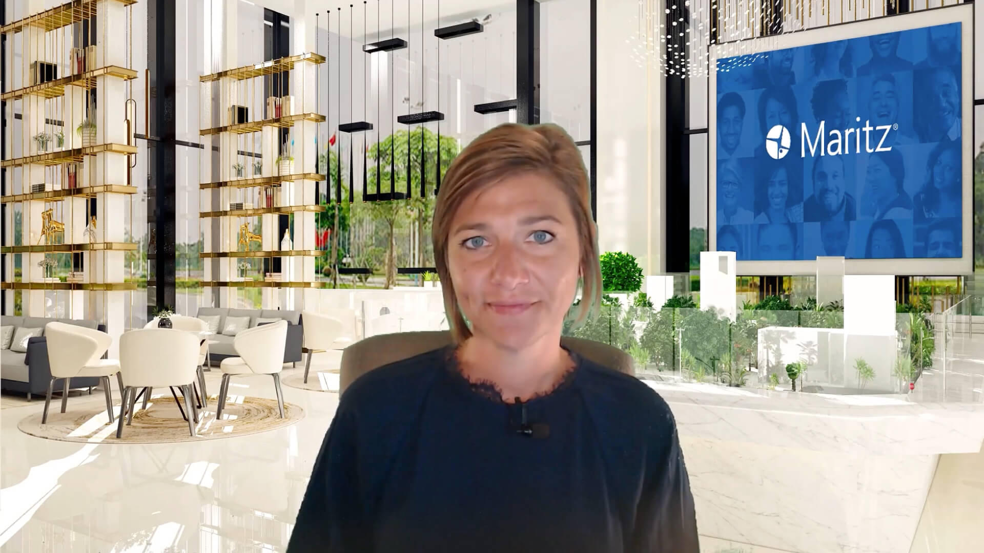 Person standing in a modern office lobby with shelves and a digital screen in the background
