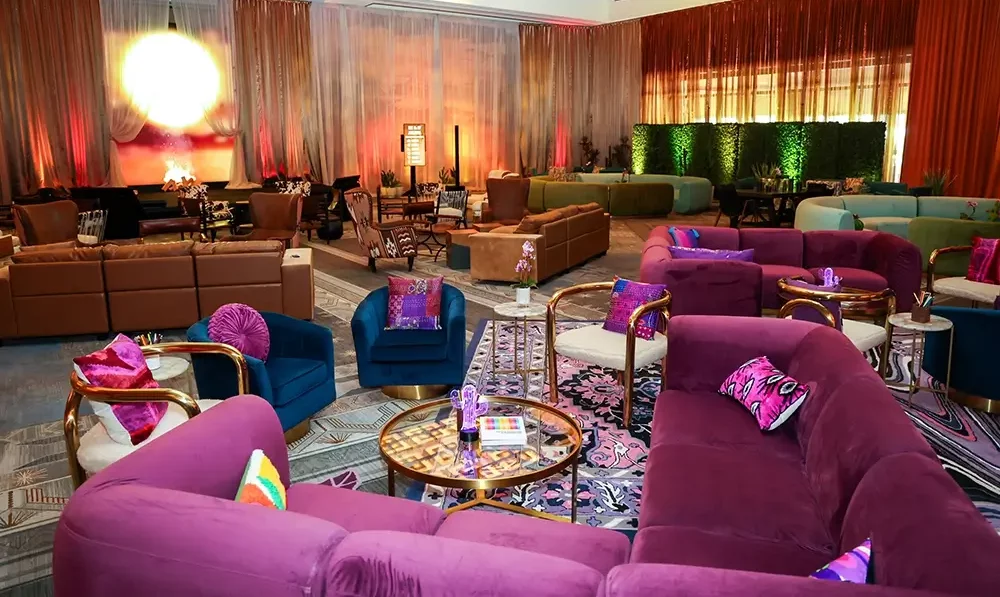 A colorfully-curated event room with a pink couch