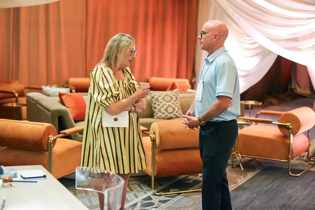 A man and woman talking in the lounge room at an event