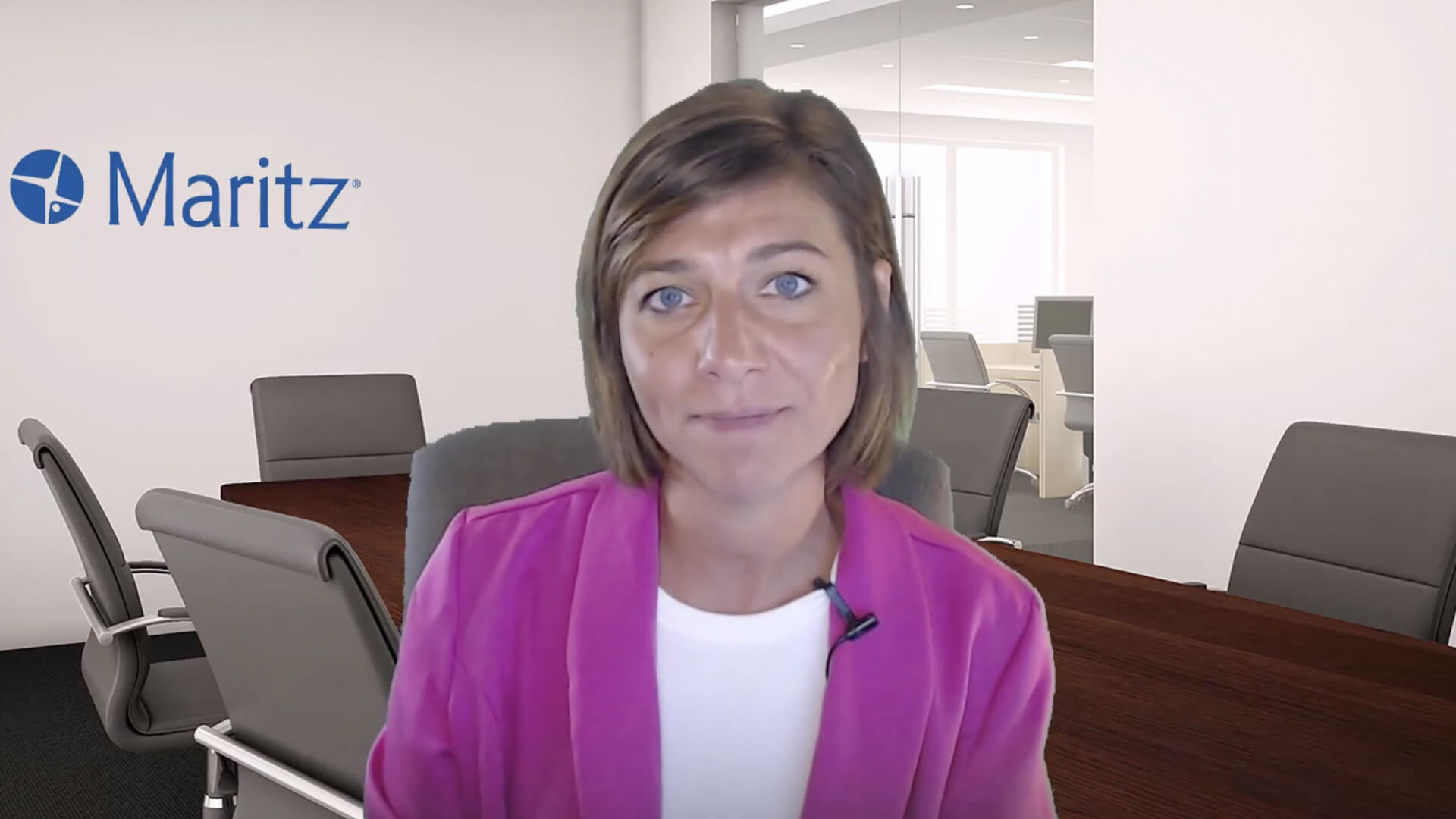 Speaker presenting insights in a Maritz office conference room during a video discussion on dealership technology and OEM strategy.