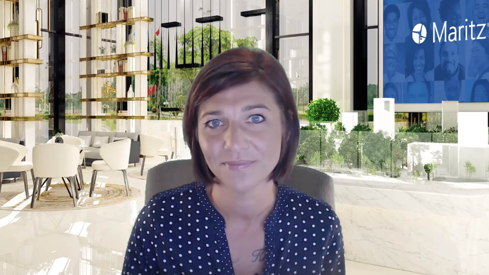Person speaking on video call with a Maritz-branded office background during a recorded video presentation.